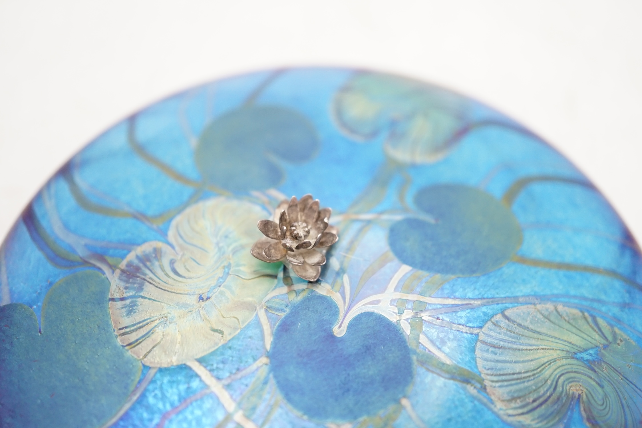 A John Ditchfield for Glasform paperweight, disc shaped with lily pad decoration and metal frog mounted in the centre,11cm diameter. Condition - frog needs re-gluing, glass paperweight good